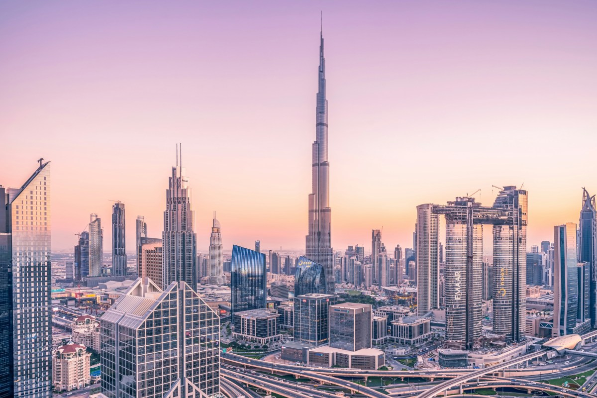 Downtown Dubai skyline at dusk with the Burj Khalifa in pink evening light